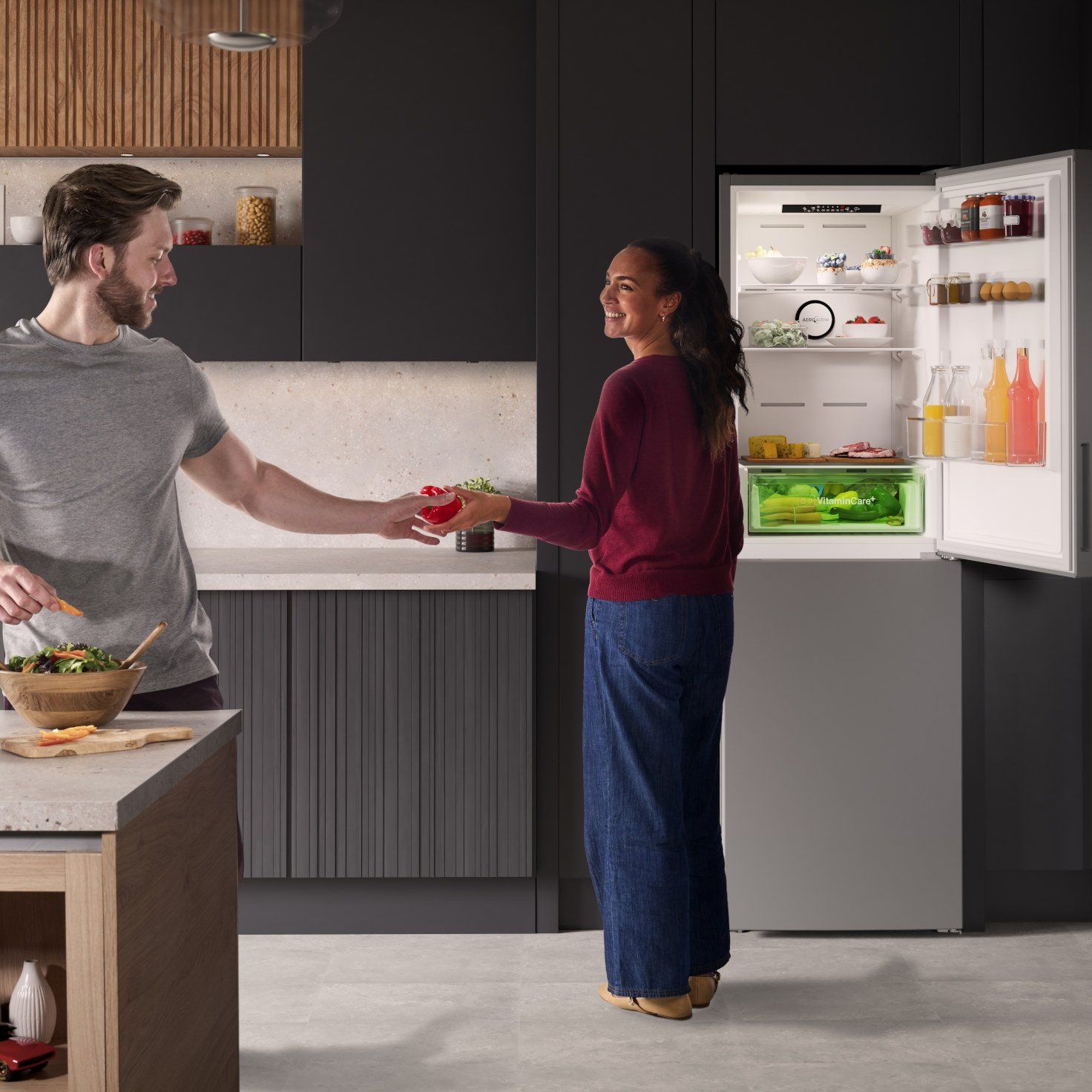 Couple in kitchen with fridge freezer